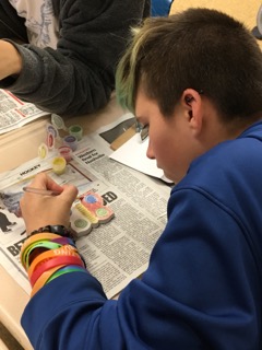 Washington Middle School student painting a butterfly.